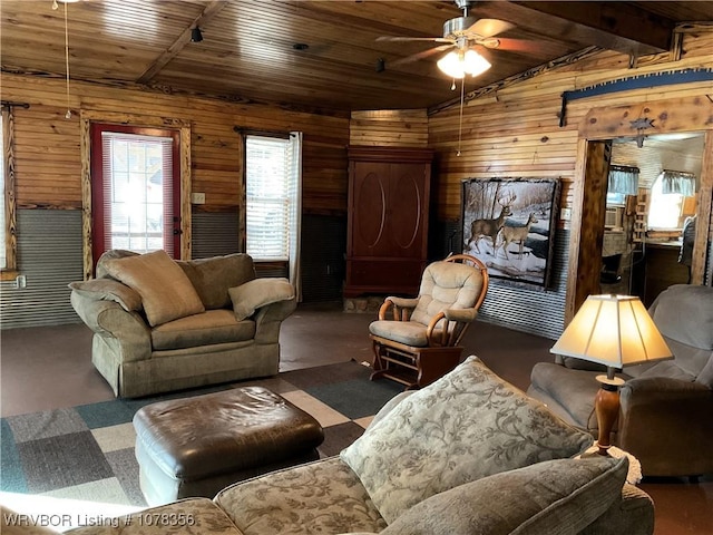 living room featuring wood ceiling, ceiling fan, and wood walls