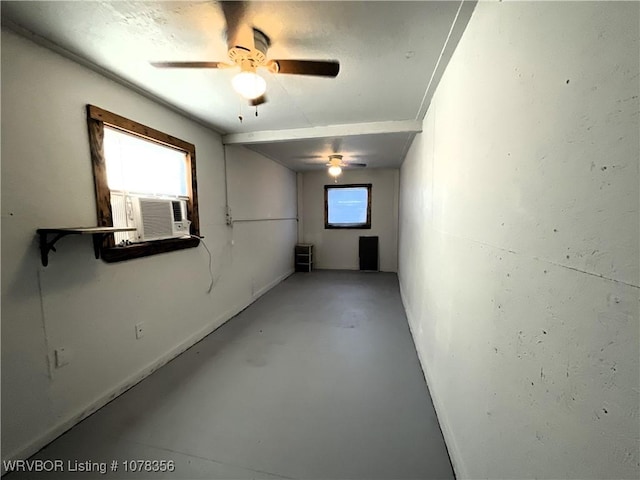 spare room featuring cooling unit, concrete flooring, and ceiling fan