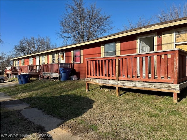 view of home's exterior featuring a deck and a yard