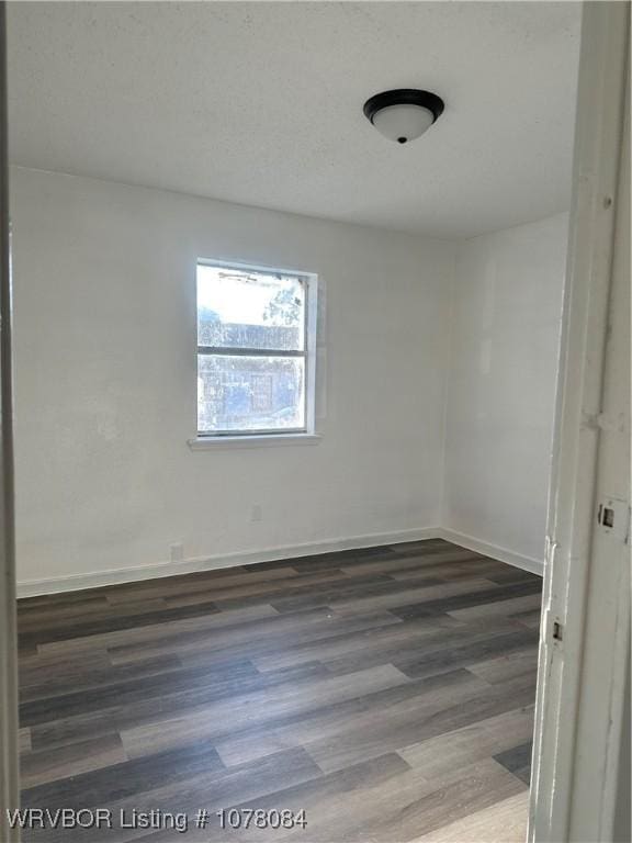 unfurnished room featuring dark hardwood / wood-style floors