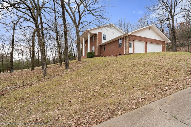 view of front facade with a garage and brick siding