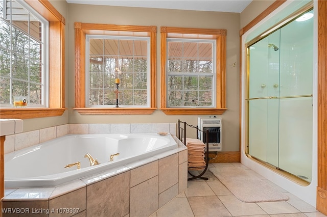 full bathroom featuring heating unit, a shower stall, and a bath