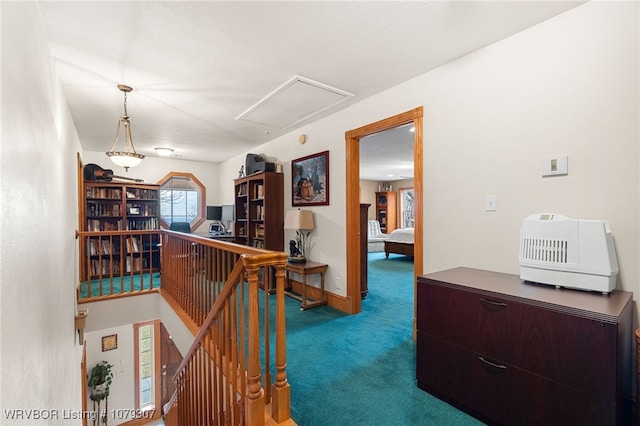 hallway featuring baseboards, carpet flooring, and an upstairs landing