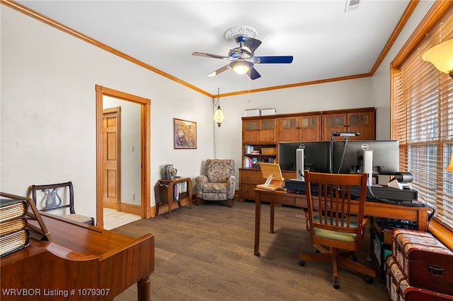 office area featuring ceiling fan, wood finished floors, visible vents, baseboards, and ornamental molding