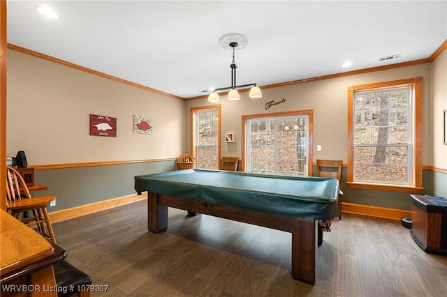 playroom featuring a healthy amount of sunlight, wood finished floors, visible vents, and crown molding