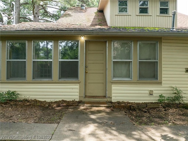 701 Witte St, Poteau, OK 74953 - property entrance featuring board and batten siding and a shingled roof