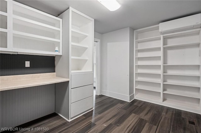701 Witte St, Poteau, OK 74953 - spacious closet with a wall mounted air conditioner and dark wood-style floors