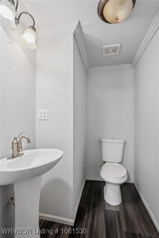 701 Witte St, Poteau, OK 74953 - bathroom featuring wood finished floors and crown molding