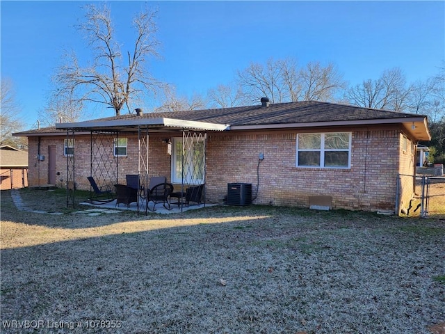 back of property featuring central AC, a lawn, and a patio