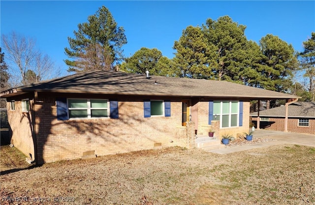 ranch-style home featuring a front yard and a carport