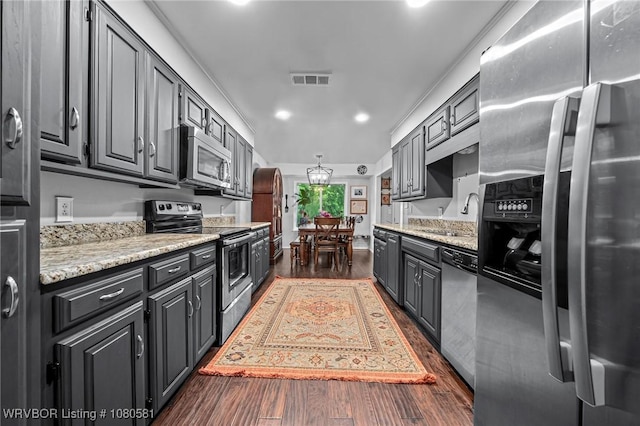 kitchen with dark wood finished floors, recessed lighting, appliances with stainless steel finishes, a sink, and visible vents
