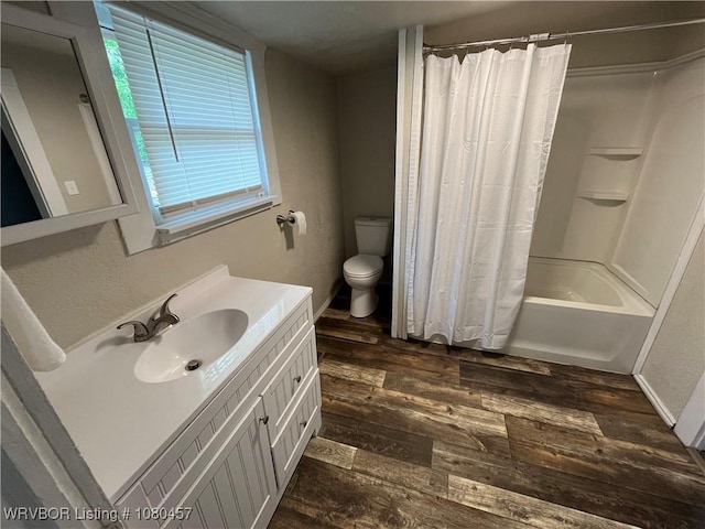 full bath with shower / bathtub combination with curtain, wood finished floors, toilet, and vanity