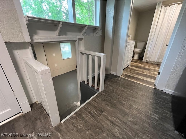interior space with wood finished floors and a textured wall
