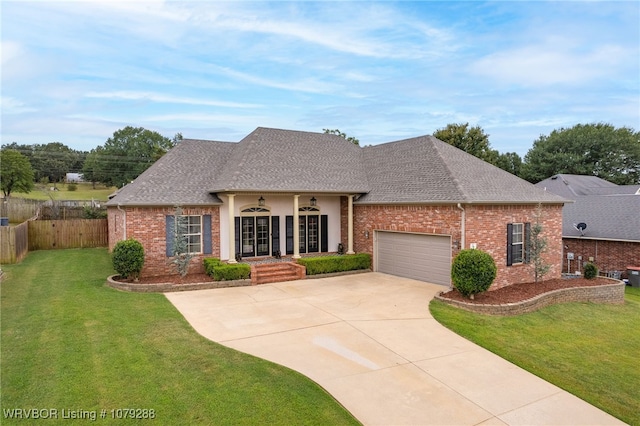 view of front of house featuring a garage, concrete driveway, brick siding, and a front lawn