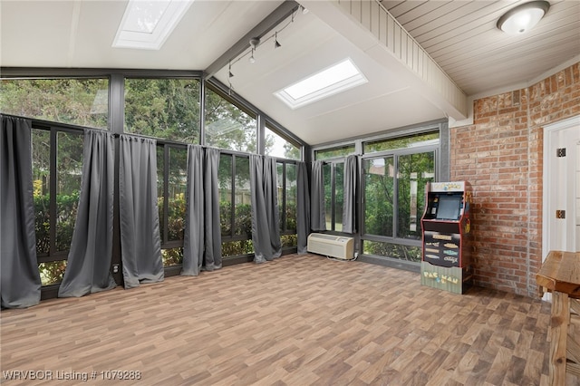 unfurnished sunroom with vaulted ceiling with skylight