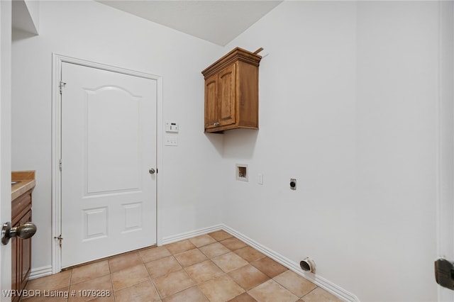 washroom featuring washer hookup, light tile patterned floors, cabinet space, hookup for an electric dryer, and baseboards