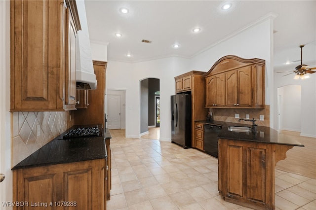 kitchen featuring arched walkways, dishwasher, a peninsula, fridge with ice dispenser, and a sink