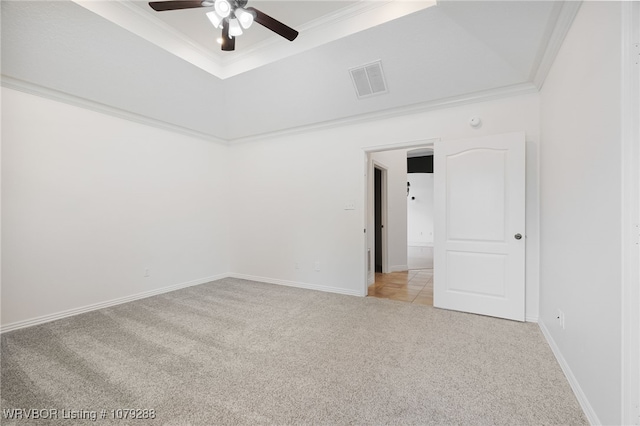 spare room with light carpet, ceiling fan, visible vents, and crown molding