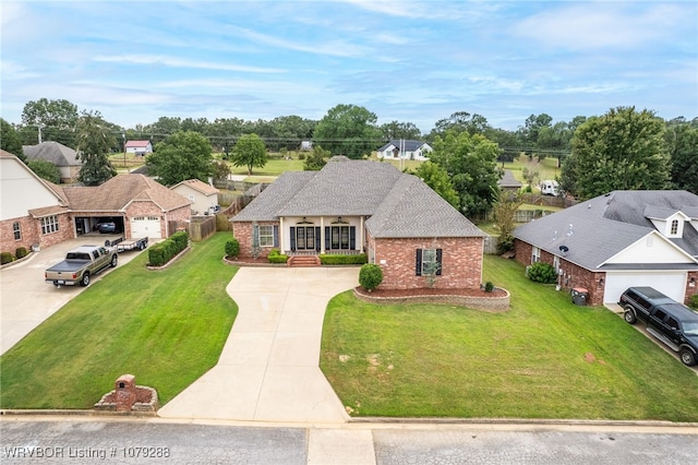 view of front of home with brick siding, a porch, a shingled roof, driveway, and a front lawn