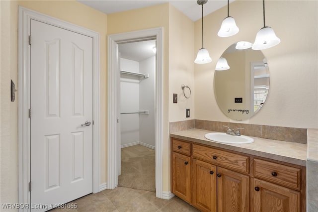 2117 Parkway Cir, Van Buren, AR 72956 - bathroom with vanity, tile patterned floors, a spacious closet, and baseboards