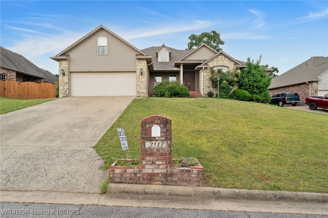 2117 Parkway Cir, Van Buren, AR 72956 - traditional-style house with stone siding, concrete driveway, and a shingled roof