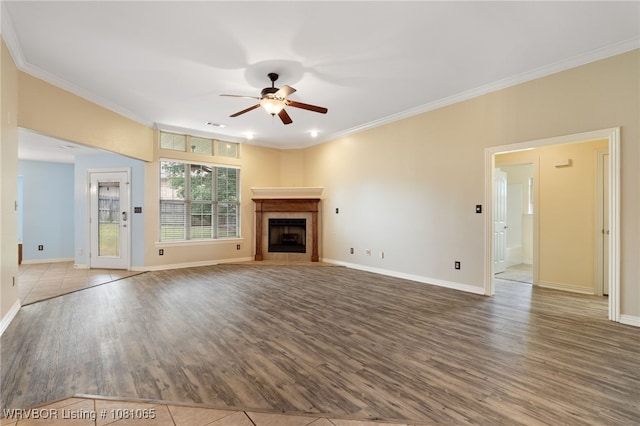 2117 Parkway Cir, Van Buren, AR 72956 - unfurnished living room with wood finished floors, a ceiling fan, crown molding, baseboards, and a tile fireplace