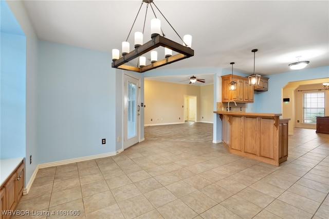 2117 Parkway Cir, Van Buren, AR 72956 - kitchen featuring arched walkways, ceiling fan, light tile patterned flooring, open floor plan, and a peninsula