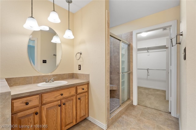 2117 Parkway Cir, Van Buren, AR 72956 - bathroom with a shower stall, a spacious closet, vanity, and tile patterned floors