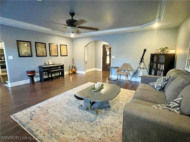 102437 S 4620th Rd, Sallisaw, OK 74955 - living area with a raised ceiling, arched walkways, ceiling fan, and wood finished floors