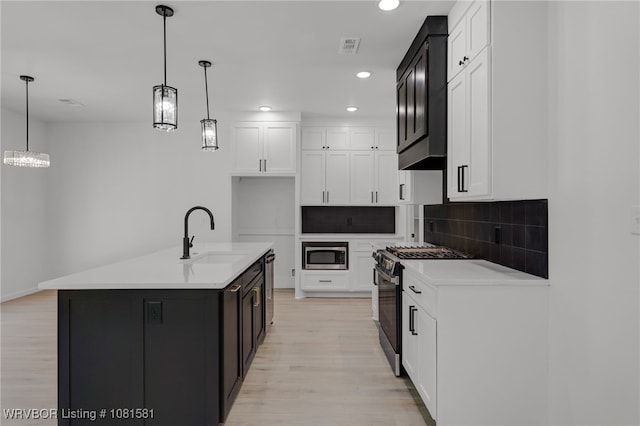 9009 Carson Way, Fort Smith, AR 72908 - kitchen featuring appliances with stainless steel finishes, a sink, light wood-style floors, backsplash, and recessed lighting