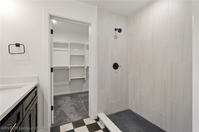 9009 Carson Way, Fort Smith, AR 72908 - bathroom with a tile shower, vanity, a walk in closet, and tile patterned floors