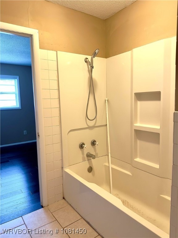 1800 N 45th Ter, Fort Smith, AR 72904 - bathroom featuring a textured ceiling, shower / bathtub combination, and tile patterned flooring