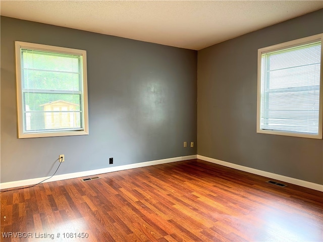 1800 N 45th Ter, Fort Smith, AR 72904 - spare room featuring plenty of natural light, wood finished floors, and baseboards