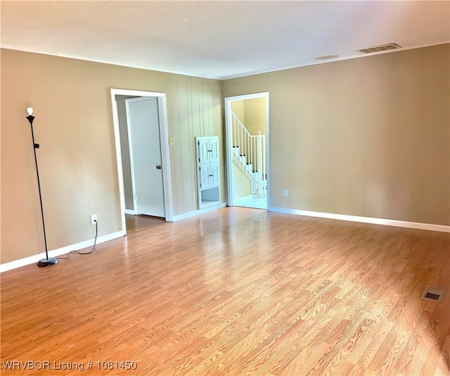 1800 N 45th Ter, Fort Smith, AR 72904 - unfurnished room featuring light wood-style flooring, baseboards, and stairway