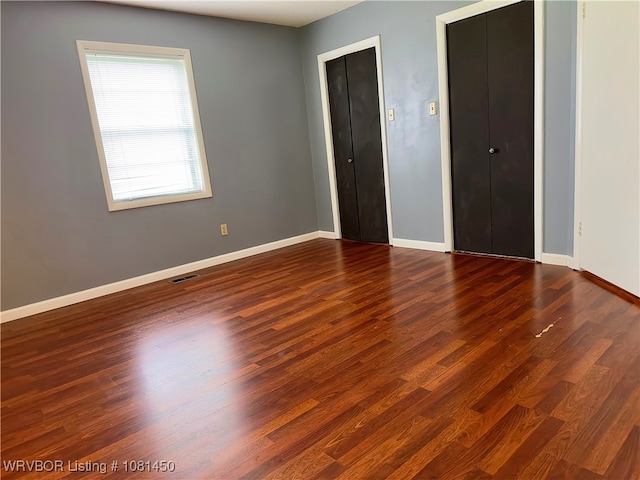 1800 N 45th Ter, Fort Smith, AR 72904 - unfurnished bedroom with baseboards and dark wood-type flooring