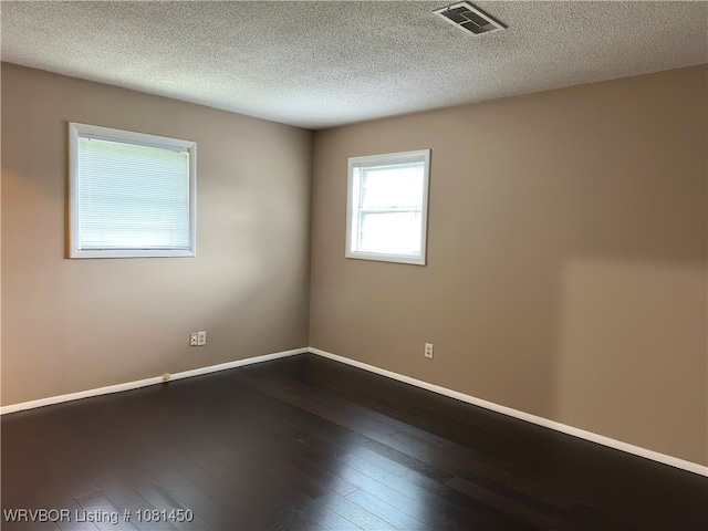1800 N 45th Ter, Fort Smith, AR 72904 - empty room featuring dark wood finished floors, baseboards, and a textured ceiling