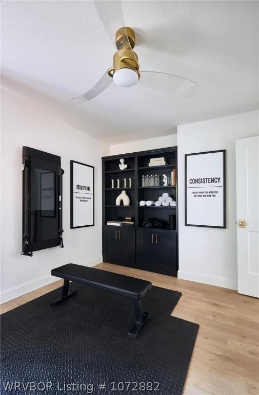 workout area with hardwood / wood-style floors