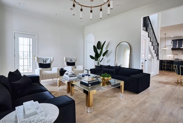 living room with light hardwood / wood-style floors and crown molding