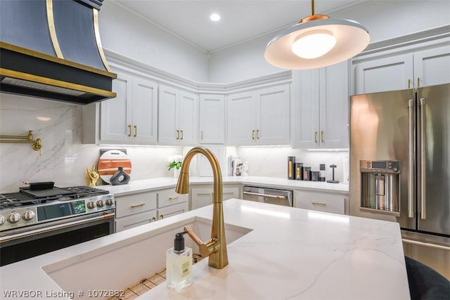 kitchen with white cabinets, backsplash, extractor fan, and high quality appliances