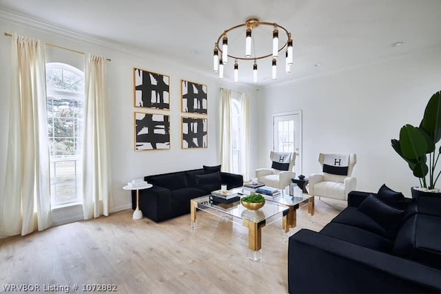 living room with light hardwood / wood-style floors, plenty of natural light, and ornamental molding