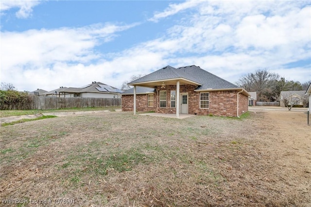 rear view of house featuring a yard and a patio area