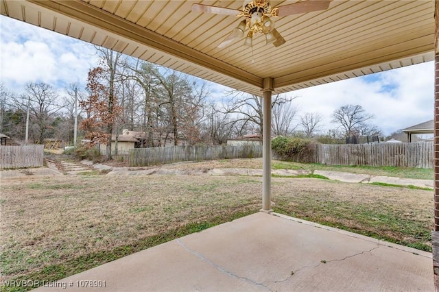 view of yard with ceiling fan and a patio area