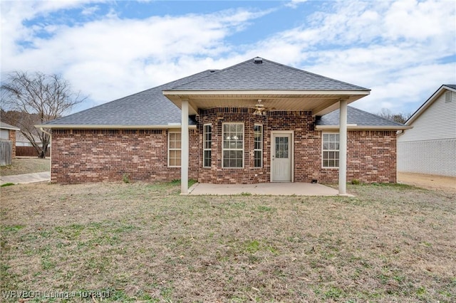 back of property featuring a yard and a patio