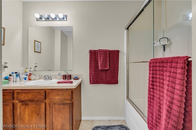 bathroom with bath / shower combo with glass door, tile patterned floors, and vanity