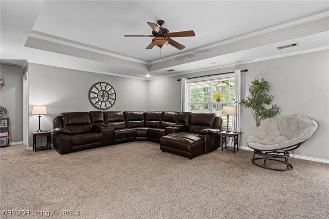 1205 S Division St, Lavaca, AR 72941 - carpeted living area with a tray ceiling, a ceiling fan, crown molding, and baseboards