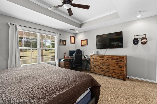 1205 S Division St, Lavaca, AR 72941 - carpeted bedroom with ornamental molding, a raised ceiling, a desk, ceiling fan, and baseboards