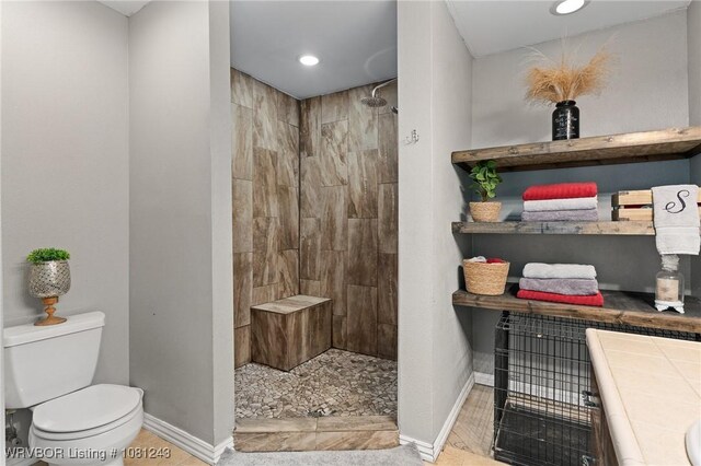 1205 S Division St, Lavaca, AR 72941 - bathroom with baseboards, toilet, tiled shower, vanity, and recessed lighting