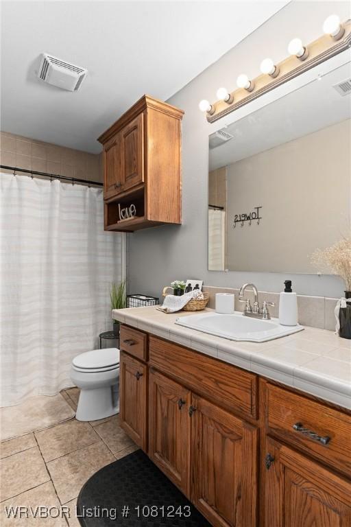 1205 S Division St, Lavaca, AR 72941 - full bathroom featuring vanity, tile patterned flooring, toilet, and a shower with curtain
