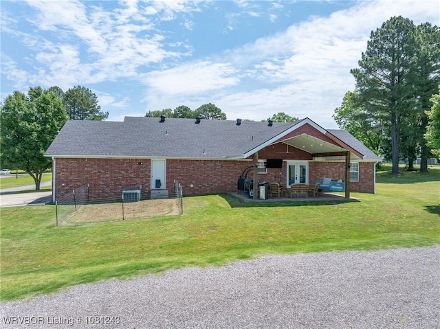 1205 S Division St, Lavaca, AR 72941 - back of house with a lawn, french doors, a patio, brick siding, and central AC