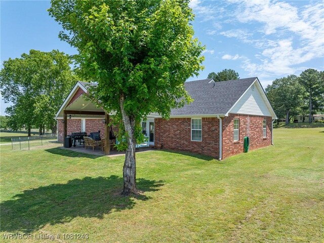 1205 S Division St, Lavaca, AR 72941 - back of property featuring brick siding, a patio, and a shingled roof